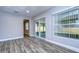 Bright living room with sliding glass doors and wood-look flooring at 11505 Blackbark Dr, Riverview, FL 33579