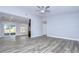 Spacious living room with wood-look floors and access to a patio at 11505 Blackbark Dr, Riverview, FL 33579