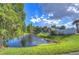 Serene pond view with lush landscaping and a community gazebo at 11505 Blackbark Dr, Riverview, FL 33579