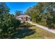 Stunning lakefront home with a circular driveway and lush landscaping at 11710 N Armenia Ave, Tampa, FL 33612