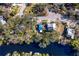 Aerial view showing home's location on riverfront lot with lush landscaping at 1214 E Park Cir, Tampa, FL 33604