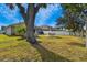 Large backyard with spacious lawn, tree, and patio at 12645 Flatwood Creek Dr, Gibsonton, FL 33534