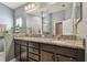 Double vanity bathroom with granite countertops and large mirror at 12645 Flatwood Creek Dr, Gibsonton, FL 33534