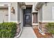 Front entrance with stone accents and a screen door at 12645 Flatwood Creek Dr, Gibsonton, FL 33534