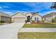 Single-story home with attached garage and landscaped lawn at 12645 Flatwood Creek Dr, Gibsonton, FL 33534