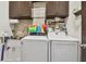 Laundry room with washer, dryer, and utility sink at 12645 Flatwood Creek Dr, Gibsonton, FL 33534