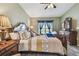 Spacious main bedroom with large bed and wood furniture at 12645 Flatwood Creek Dr, Gibsonton, FL 33534