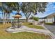 Relaxing patio with seating area and fire pit, overlooking lake at 12645 Flatwood Creek Dr, Gibsonton, FL 33534