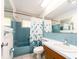 Bathroom with teal tile, tub, and shower at 14052 89Th Ave, Seminole, FL 33776