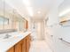 Bright bathroom with double sinks, shower, and bathtub at 14052 89Th Ave, Seminole, FL 33776