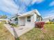 White building with green awnings and concrete pathway at 14052 89Th Ave, Seminole, FL 33776