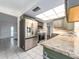 Modern kitchen features stainless steel appliances and granite countertops at 14052 89Th Ave, Seminole, FL 33776