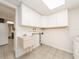 Laundry room with built-in cabinets and a utility sink at 14052 89Th Ave, Seminole, FL 33776