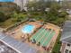 Aerial view of community pool, shuffleboard courts, and residents enjoying recreation at 1524 Lakeview Rd # 305, Clearwater, FL 33756