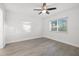 Bright bedroom with ceiling fan and wood-look floors at 1524 Lakeview Rd # 305, Clearwater, FL 33756