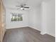 Bright bedroom with ceiling fan and wood-look floors at 1524 Lakeview Rd # 305, Clearwater, FL 33756