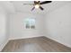 Well-lit bedroom, ceiling fan, and wood-look floors at 1524 Lakeview Rd # 305, Clearwater, FL 33756