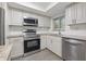 Modern kitchen with stainless steel appliances and granite countertops at 1524 Lakeview Rd # 305, Clearwater, FL 33756