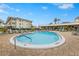 Relaxing community pool with surrounding patio furniture at 1524 Lakeview Rd # 305, Clearwater, FL 33756