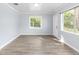 Light and airy living room with wood-look floors and windows at 16212 Snow Memorial Hwy, Brooksville, FL 34601