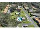 Aerial view of community featuring pool, tennis court, and numerous buildings at 1701 Pinehurst Rd # 33A, Dunedin, FL 34698