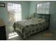 Bedroom with floral bedding and large windows at 1701 Pinehurst Rd # 33A, Dunedin, FL 34698