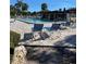 Relaxing community pool area with blue lounge chairs at 1701 Pinehurst Rd # 33A, Dunedin, FL 34698