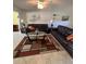 Spacious living room with leather sofas, coffee table, and sliding glass doors at 1701 Pinehurst Rd # 33A, Dunedin, FL 34698