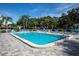 Community pool with plenty of lounge chairs for relaxing at 1701 Pinehurst Rd # 33A, Dunedin, FL 34698