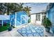 Backyard features a blue shed and patterned outdoor rug at 17744 1St E St, Redington Shores, FL 33708