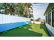 Artificial turf backyard with white fence and water views at 17744 1St E St, Redington Shores, FL 33708