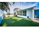 Artificial turf backyard with sunroom and storage shed at 17744 1St E St, Redington Shores, FL 33708