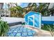 Backyard with shed and patterned rug, creating a cozy space at 17744 1St E St, Redington Shores, FL 33708