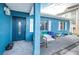 View of the front entrance of a charming blue house with a dark blue door and white shutters at 17744 1St E St, Redington Shores, FL 33708