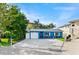 Blue house with white garage door and artificial turf at 17744 1St E St, Redington Shores, FL 33708