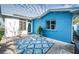 Home exterior showcasing blue walls and a patio area at 17744 1St E St, Redington Shores, FL 33708