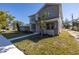 Two-story craftsman home with gray siding, stone accents, and a landscaped lawn at 1810 32Nd N Ave, St Petersburg, FL 33713