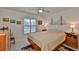 Cozy bedroom with a double bed, ceiling fan, and mid-century furniture at 1943 S Pebble Beach Blvd, Sun City Center, FL 33573