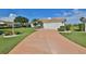 Home exterior with driveway and manicured lawn at 1943 S Pebble Beach Blvd, Sun City Center, FL 33573