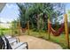 Relaxing backyard with patio, hammocks, and lush greenery at 1949 Forked Creek Dr, Englewood, FL 34223