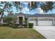 Beautiful two-story home with three-car garage and landscaped lawn at 2111 Climbing Ivy Dr, Tampa, FL 33618