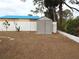 Backyard with storage shed and low-maintenance landscaping at 237 Orduna Dr, North Port, FL 34287