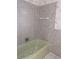 Retro bathroom with light green tub and tiled walls at 237 Orduna Dr, North Port, FL 34287