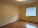 Simple bedroom with hardwood floors and a window at 237 Orduna Dr, North Port, FL 34287