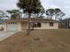 Ranch-style home with attached garage and palm tree at 237 Orduna Dr, North Port, FL 34287