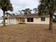 Ranch-style home with a large yard and attached garage at 237 Orduna Dr, North Port, FL 34287