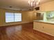 Spacious living area with hardwood floors and kitchen access at 237 Orduna Dr, North Port, FL 34287