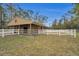 Wooden barn with white fence at 249 Dogwood Trce, Tarpon Springs, FL 34688