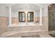 Elegant bathroom featuring a large soaking tub and a chandelier at 249 Dogwood Trce, Tarpon Springs, FL 34688