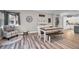 Farmhouse-style dining room with white table, bench and access to kitchen at 249 Dogwood Trce, Tarpon Springs, FL 34688